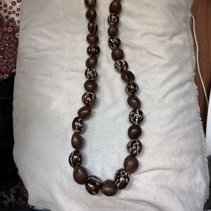 Hawaiian brown beads necklace made from Kukui nuts, measures 34 inches.